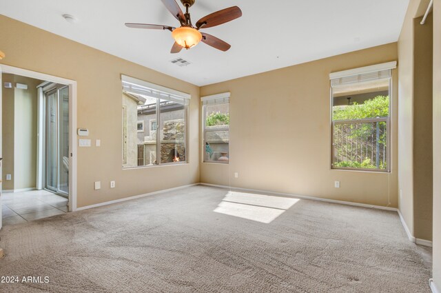 unfurnished bedroom with ceiling fan, connected bathroom, access to exterior, and light carpet