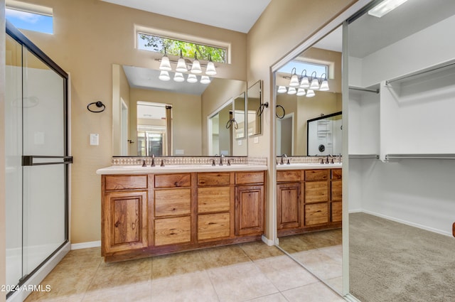 bathroom with vanity, an enclosed shower, and tile patterned floors