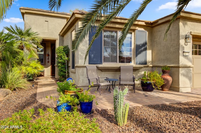 back of property with a patio