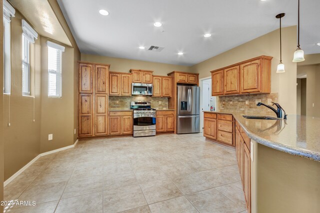 kitchen with dishwasher, decorative light fixtures, a notable chandelier, kitchen peninsula, and tasteful backsplash