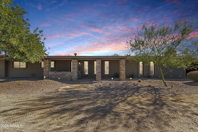 12423 N 64th St, Scottsdale, AZ 85254 - view of front of property with covered porch, stucco siding, and stone siding