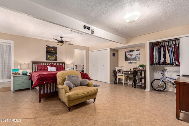 12423 N 64th St, Scottsdale, AZ 85254 - bedroom with a textured ceiling, light tile patterned flooring, two closets, baseboards, and ceiling fan