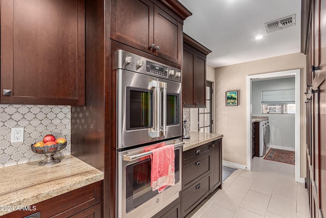 12423 N 64th St, Scottsdale, AZ 85254 - kitchen with stainless steel double oven, dark brown cabinetry, washing machine and clothes dryer, decorative backsplash, and light tile patterned floors