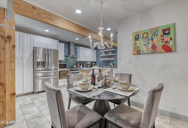 tiled dining space with a chandelier and sink