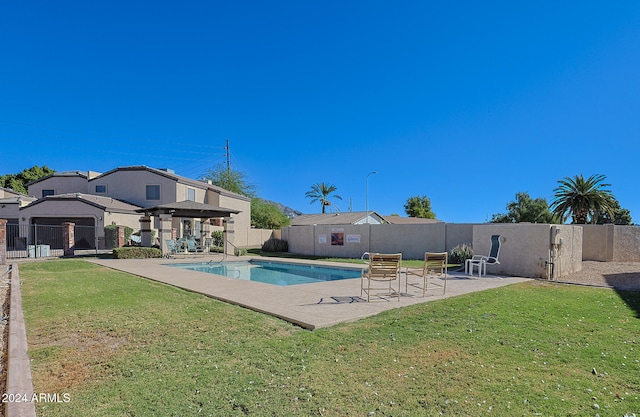 view of swimming pool featuring a yard and a patio