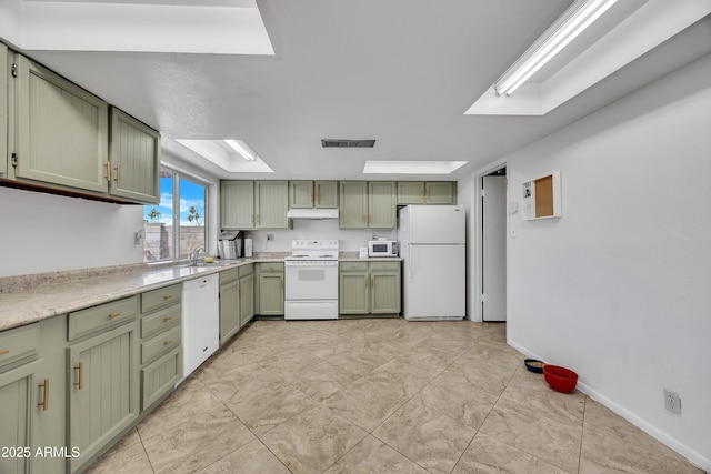 kitchen featuring white appliances, visible vents, light countertops, under cabinet range hood, and green cabinets