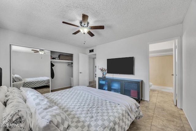 tiled bedroom with visible vents, a textured ceiling, a closet, and ceiling fan