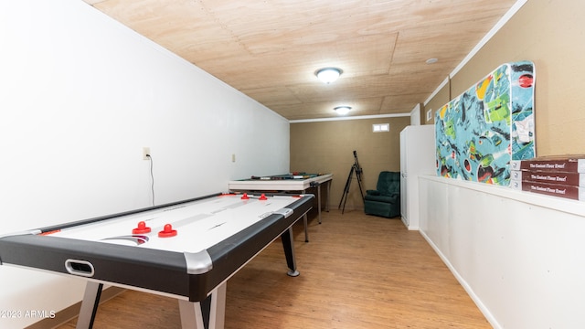 playroom featuring ornamental molding, light hardwood / wood-style floors, and wooden ceiling