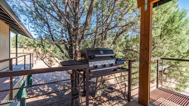 wooden deck featuring a grill