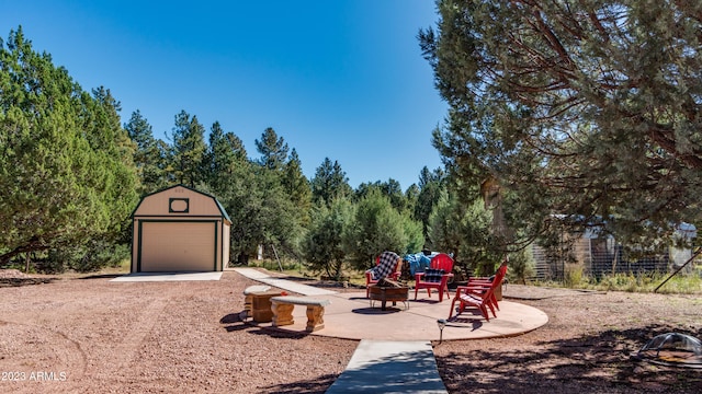 exterior space featuring an outdoor fire pit and an outbuilding