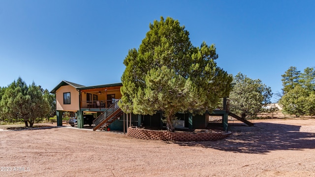 exterior space with ceiling fan