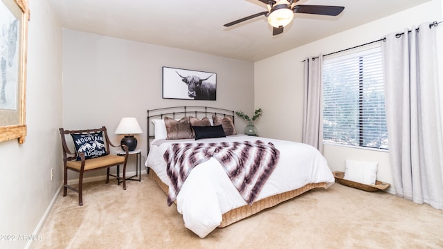 bedroom featuring light colored carpet and ceiling fan