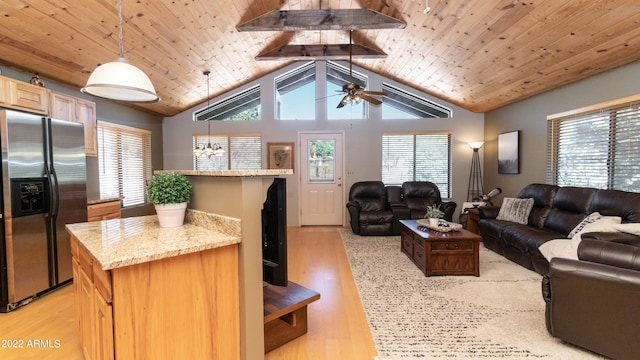 living room featuring light hardwood / wood-style flooring, lofted ceiling with beams, and plenty of natural light