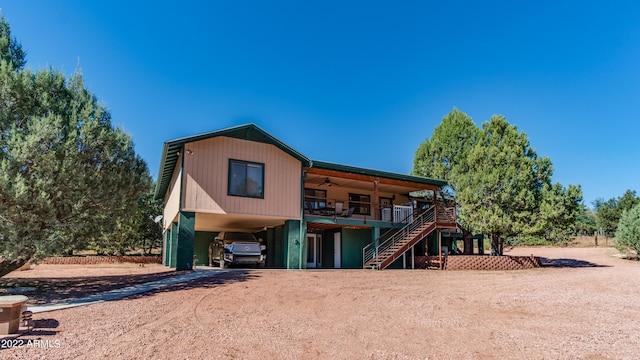 rear view of house featuring a carport