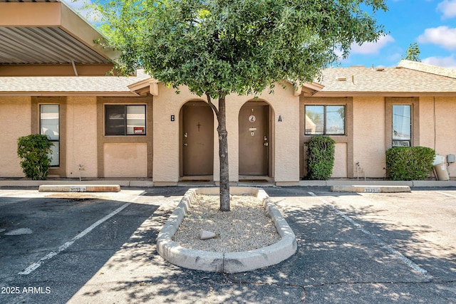 3027 E Grandview Rd Unit 1, Phoenix, AZ 85032 - view of front of property with uncovered parking, stucco siding, and a shingled roof