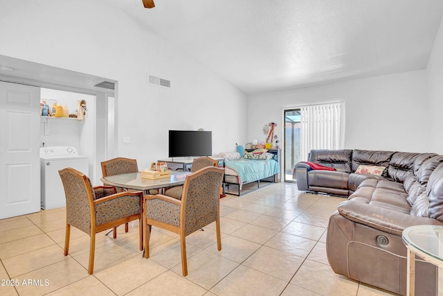 3027 E Grandview Rd Unit 1, Phoenix, AZ 85032 - dining room with light tile patterned floors, lofted ceiling, and washing machine and clothes dryer