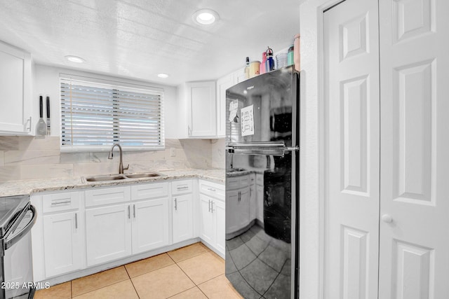 3027 E Grandview Rd Unit 1, Phoenix, AZ 85032 - kitchen with electric range, light tile patterned floors, white cabinetry, decorative backsplash, and recessed lighting