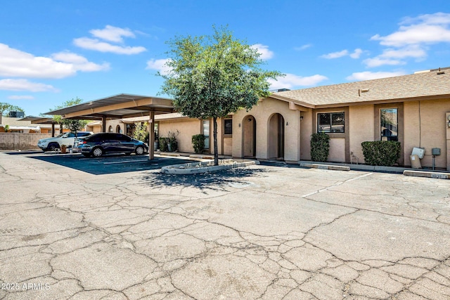 3027 E Grandview Rd Unit 1, Phoenix, AZ 85032 - view of front facade featuring covered and uncovered parking and stucco siding