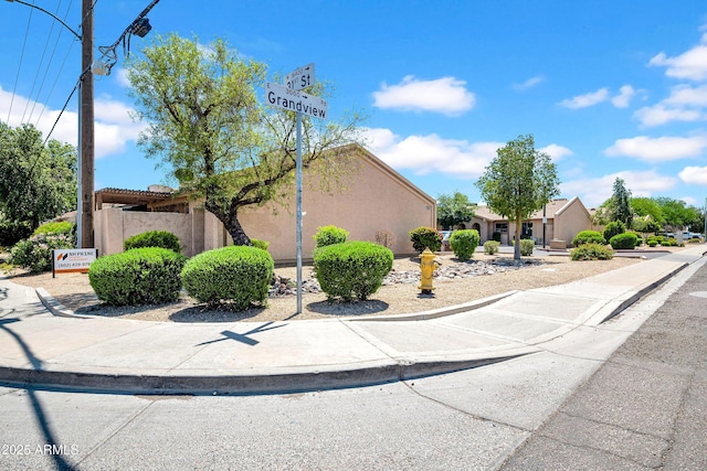 3027 E Grandview Rd Unit 1, Phoenix, AZ 85032 - view of property hidden behind natural elements featuring stucco siding