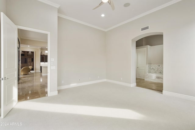 carpeted empty room featuring ceiling fan and ornamental molding