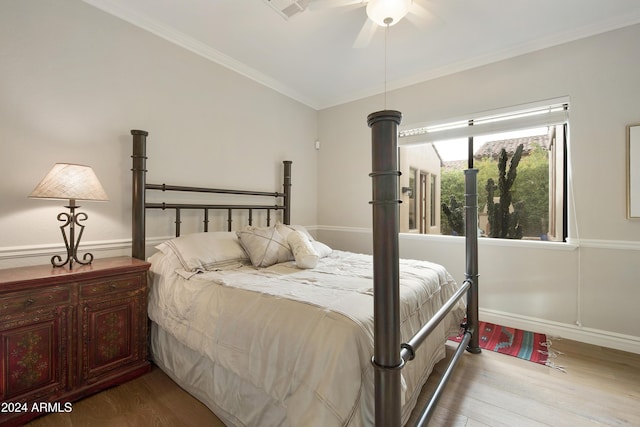 bedroom with ceiling fan, light hardwood / wood-style floors, and ornamental molding