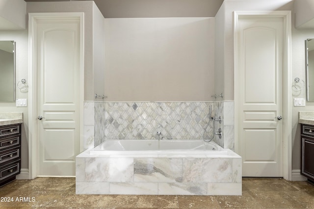 bathroom with vanity and tiled bath