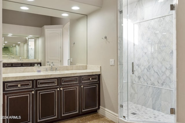 bathroom featuring vanity and an enclosed shower