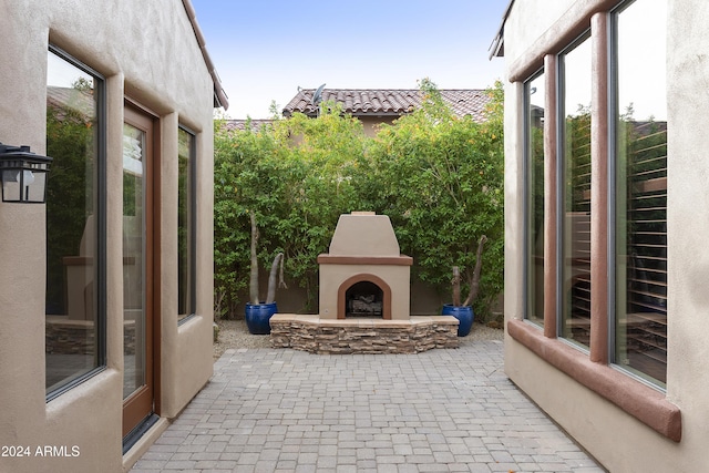 view of patio with an outdoor stone fireplace