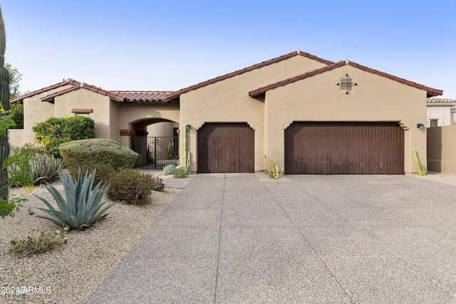 mediterranean / spanish house featuring a garage