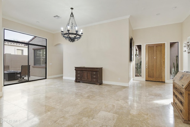 unfurnished room featuring ornamental molding and an inviting chandelier