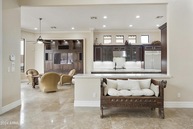 living room with ceiling fan, crown molding, and sink