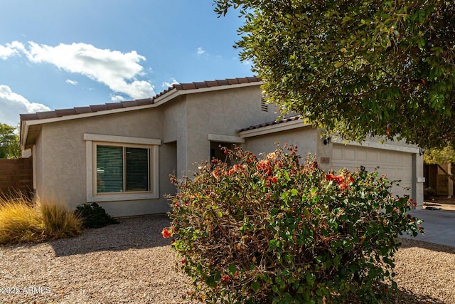 view of side of home with a garage