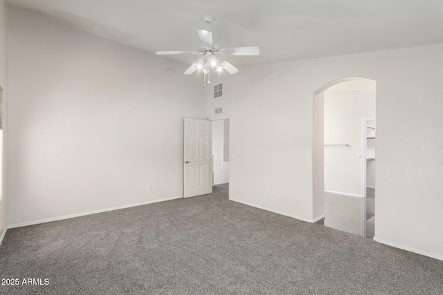 spare room with high vaulted ceiling, ceiling fan, and carpet flooring