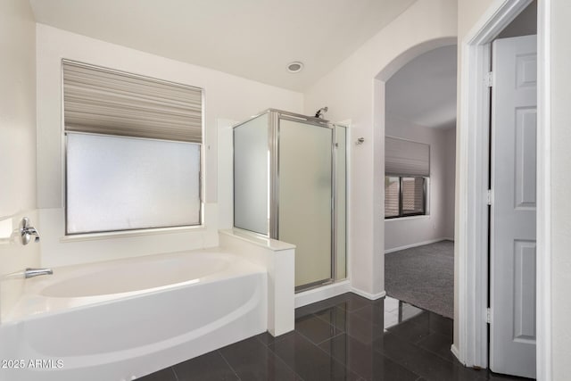 bathroom featuring tile patterned floors and shower with separate bathtub