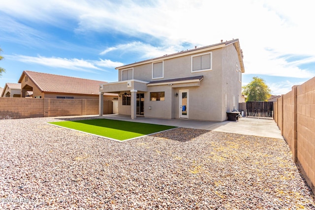 back of property with a patio