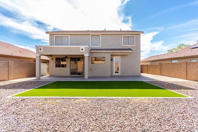 back of property with ceiling fan and a patio area