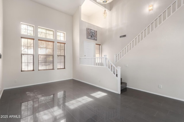 interior space featuring a high ceiling and dark hardwood / wood-style floors