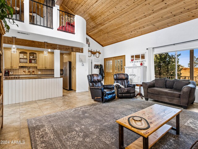 living room featuring high vaulted ceiling, wooden ceiling, light tile patterned floors, and sink