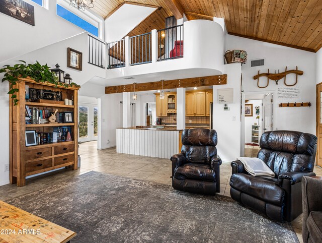 living room with high vaulted ceiling, beam ceiling, wooden ceiling, and light tile patterned floors