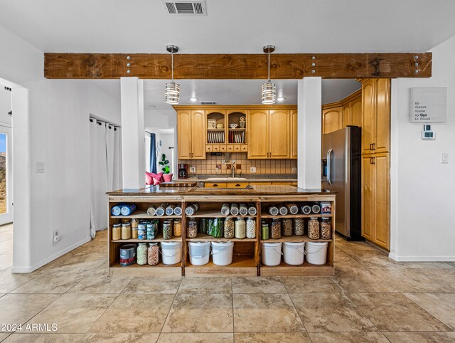 kitchen featuring stainless steel refrigerator with ice dispenser, light tile patterned floors, backsplash, and pendant lighting