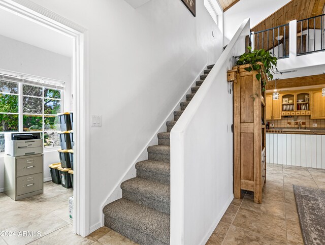 staircase featuring tile patterned floors