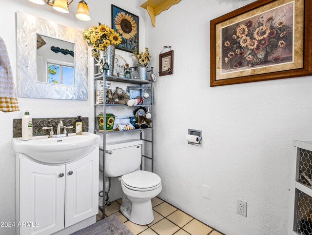 bathroom with tile patterned flooring, vanity, and toilet