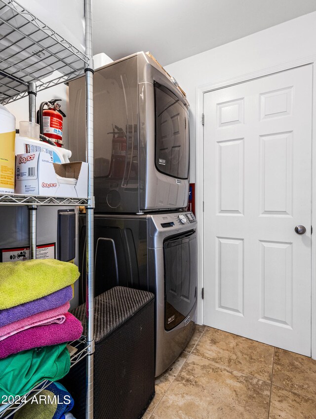 clothes washing area featuring stacked washing maching and dryer