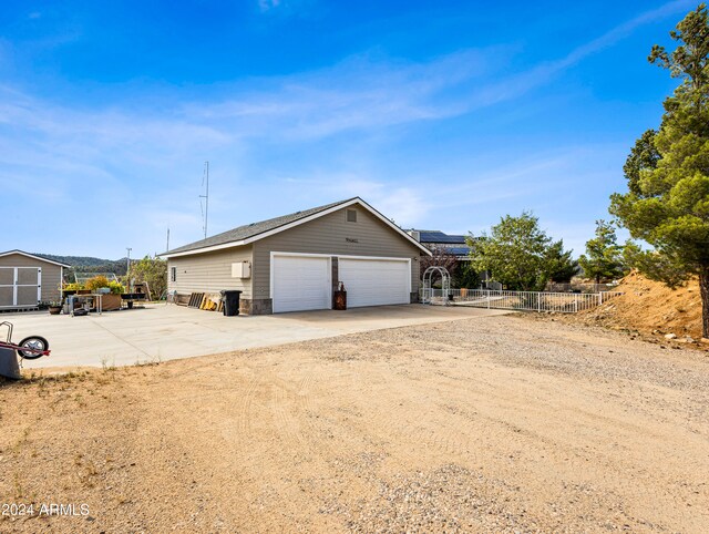 view of side of home with an outdoor structure and a garage