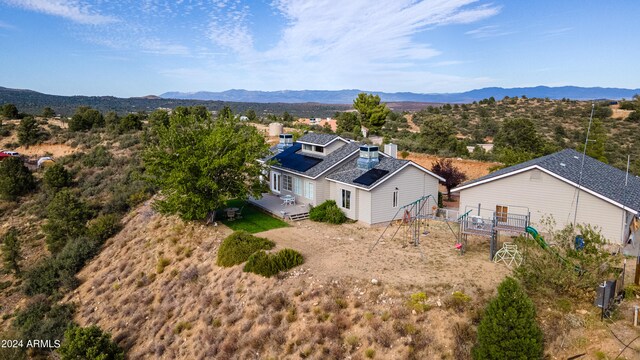 birds eye view of property featuring a mountain view