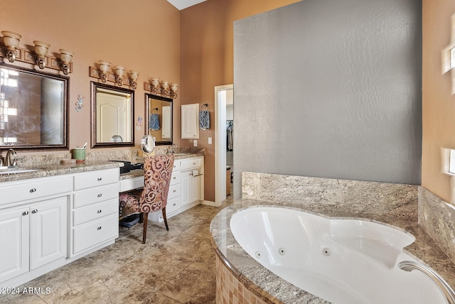 bathroom with vanity and tiled bath