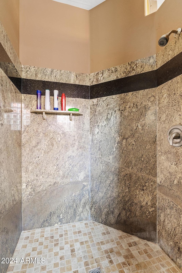 bathroom with a tile shower