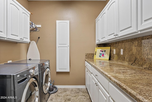 clothes washing area with cabinets, independent washer and dryer, and light tile patterned flooring