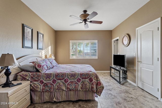 bedroom with ceiling fan and light tile patterned floors