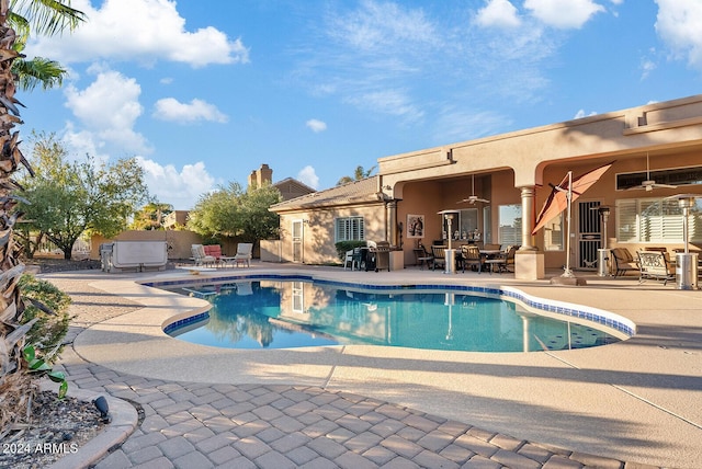 view of pool featuring ceiling fan and a patio area